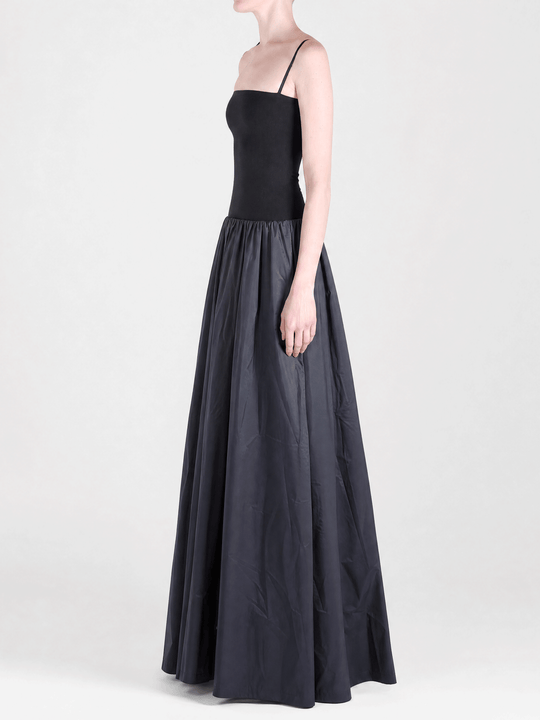 Black dress worn by a person, side view