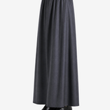 Black skirts worn by a person, showing the skirts fit
