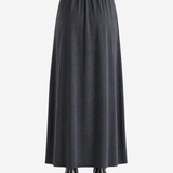 Black skirts worn by a person, showing the skirts fit