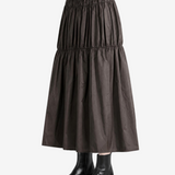 Brown skirt worn by a person, side view