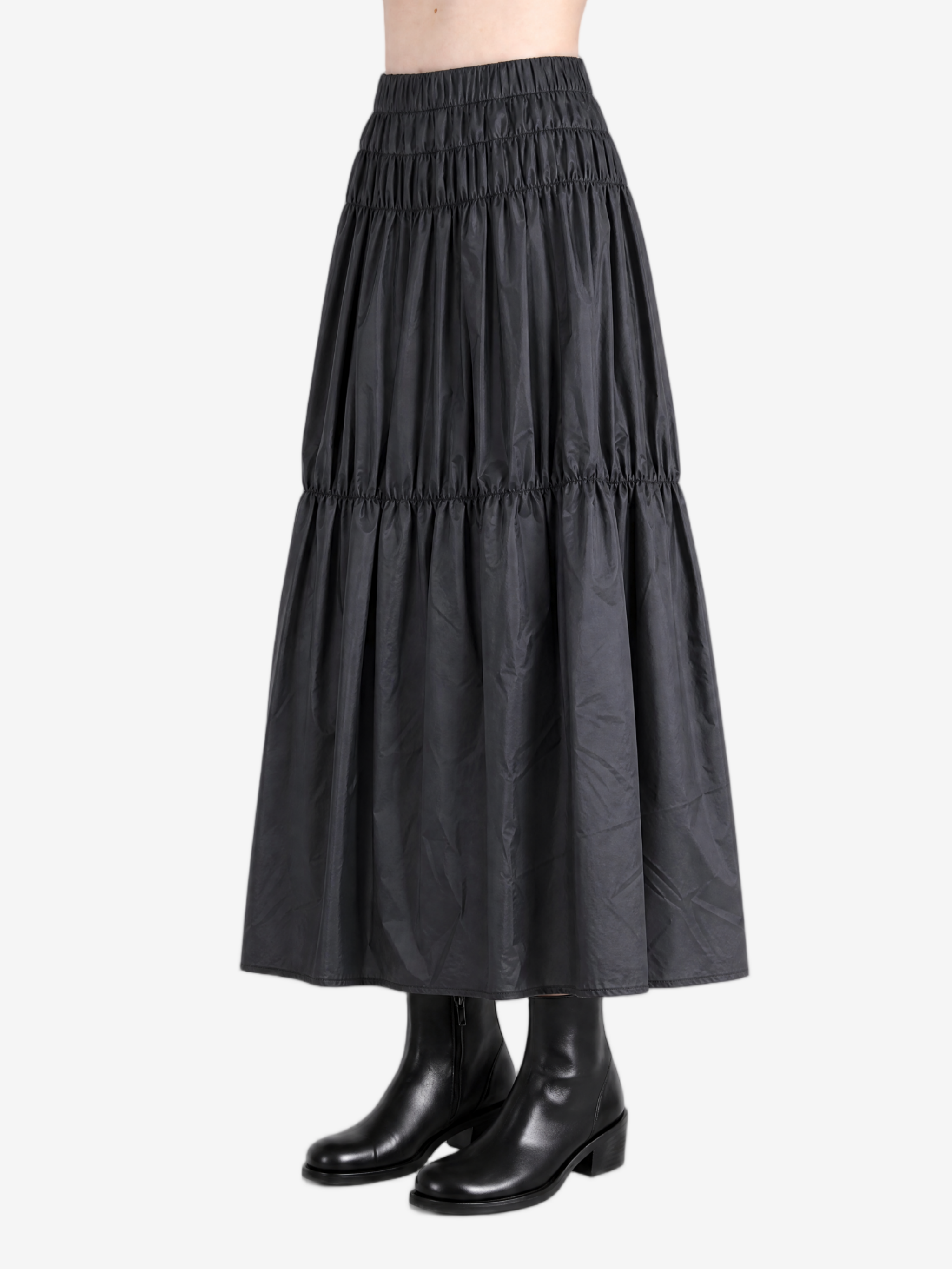 Black skirt worn by a person, side view