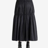 Black skirt worn by a person, back view