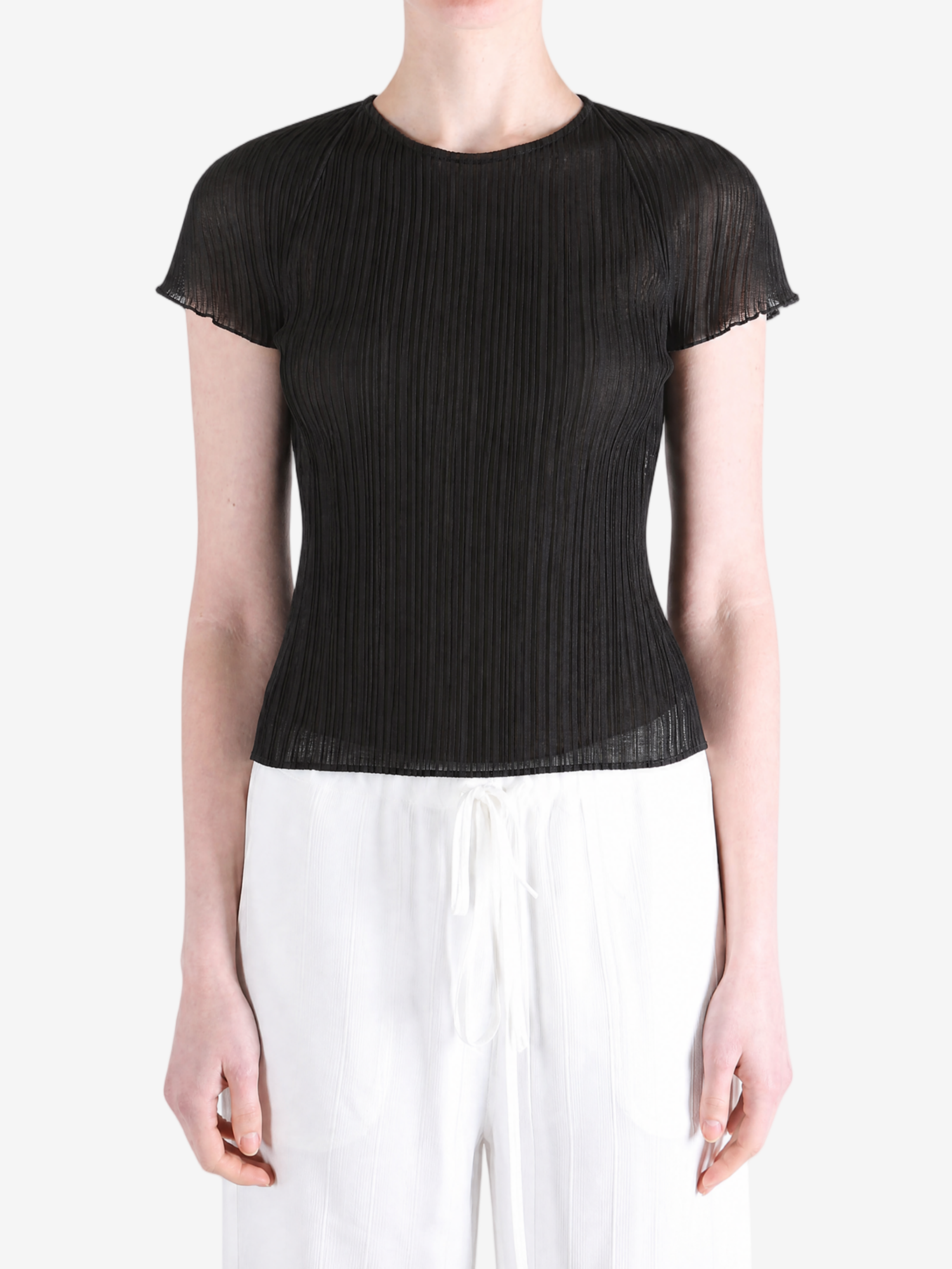 Black top worn by a person, showing the top fit