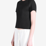 Black top worn by a person, showing the top fit