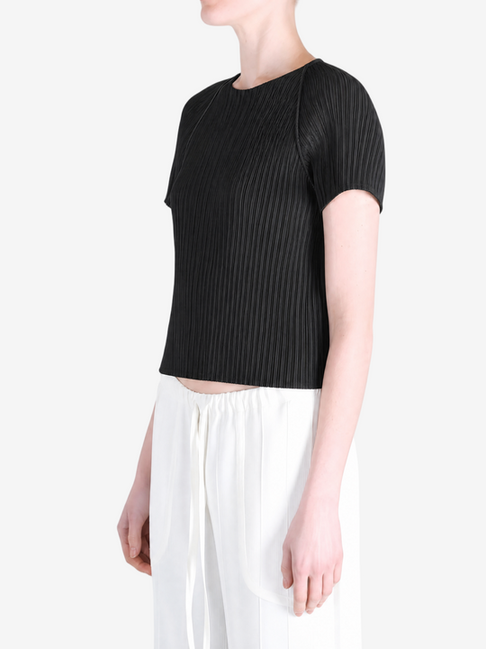 Black top worn by a person, showing the top fit