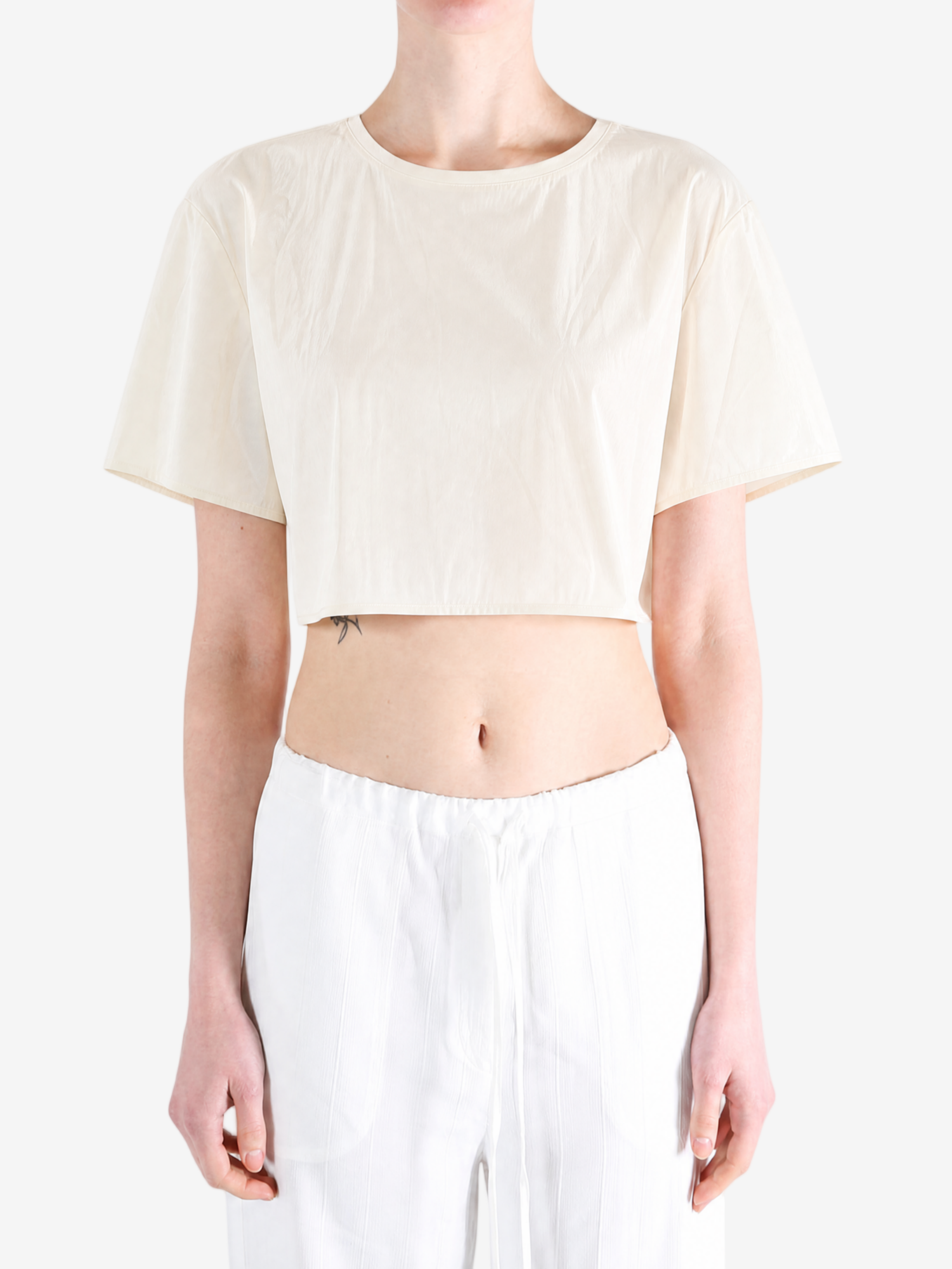 White top worn by a person, showing the top fit