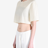 White top worn by a person, side view