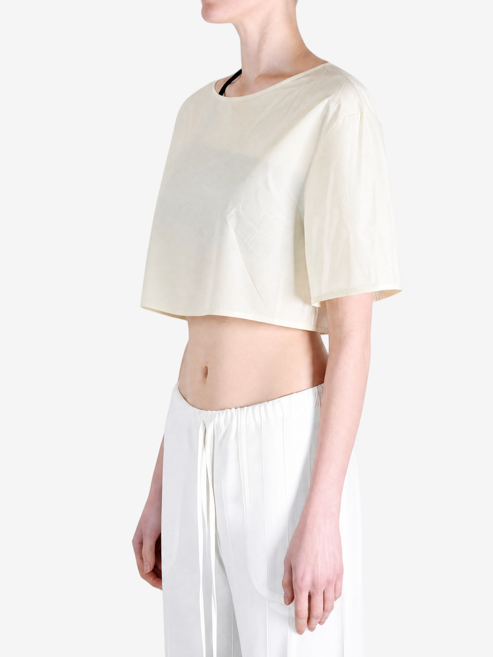 White top worn by a person, side view