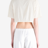 White top worn by a person, back view
