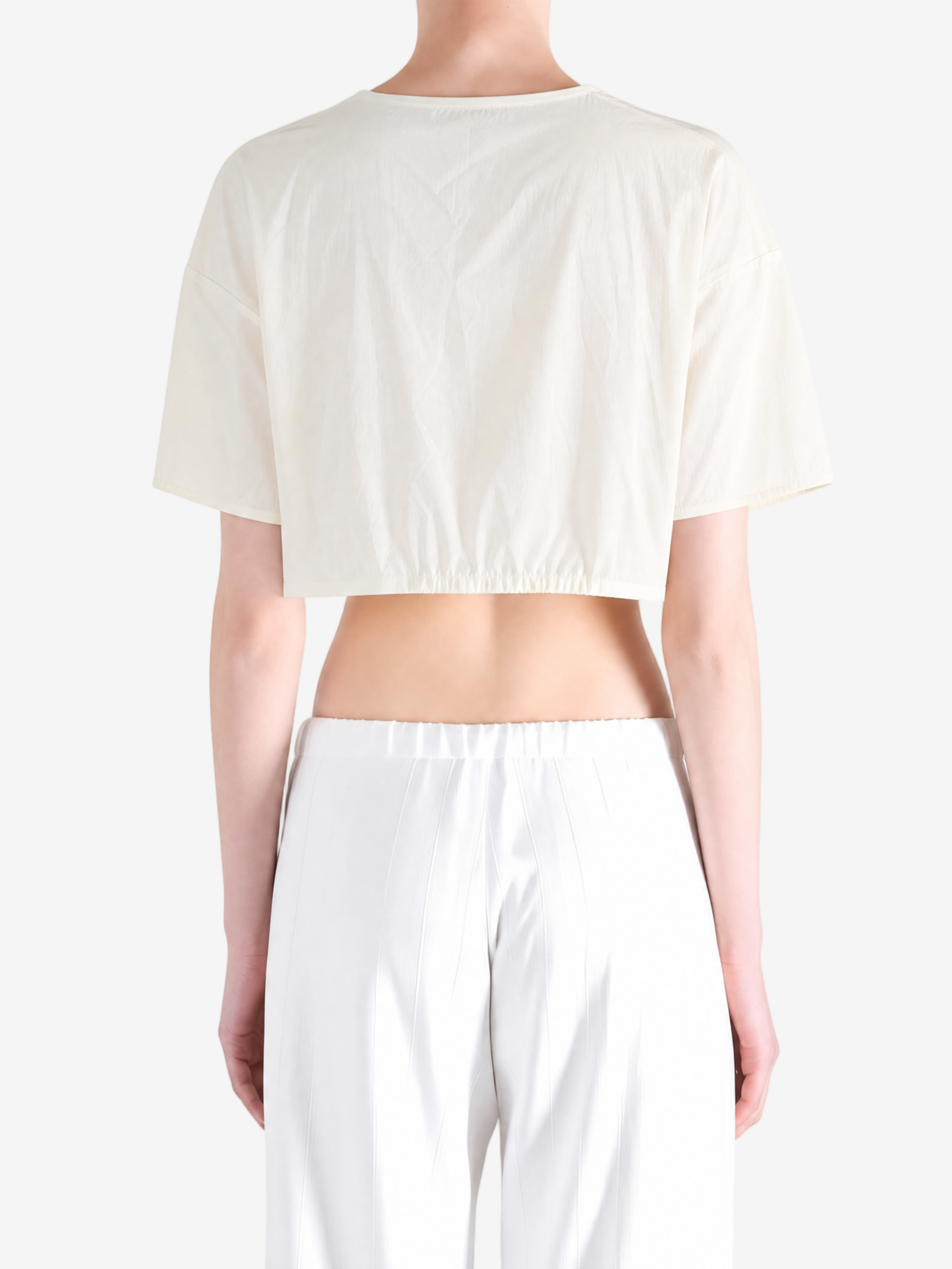 White top worn by a person, back view