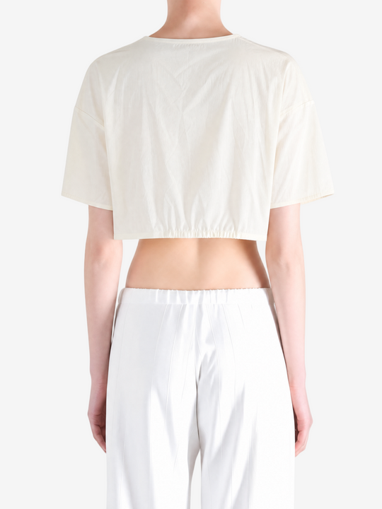 White top worn by a person, back view