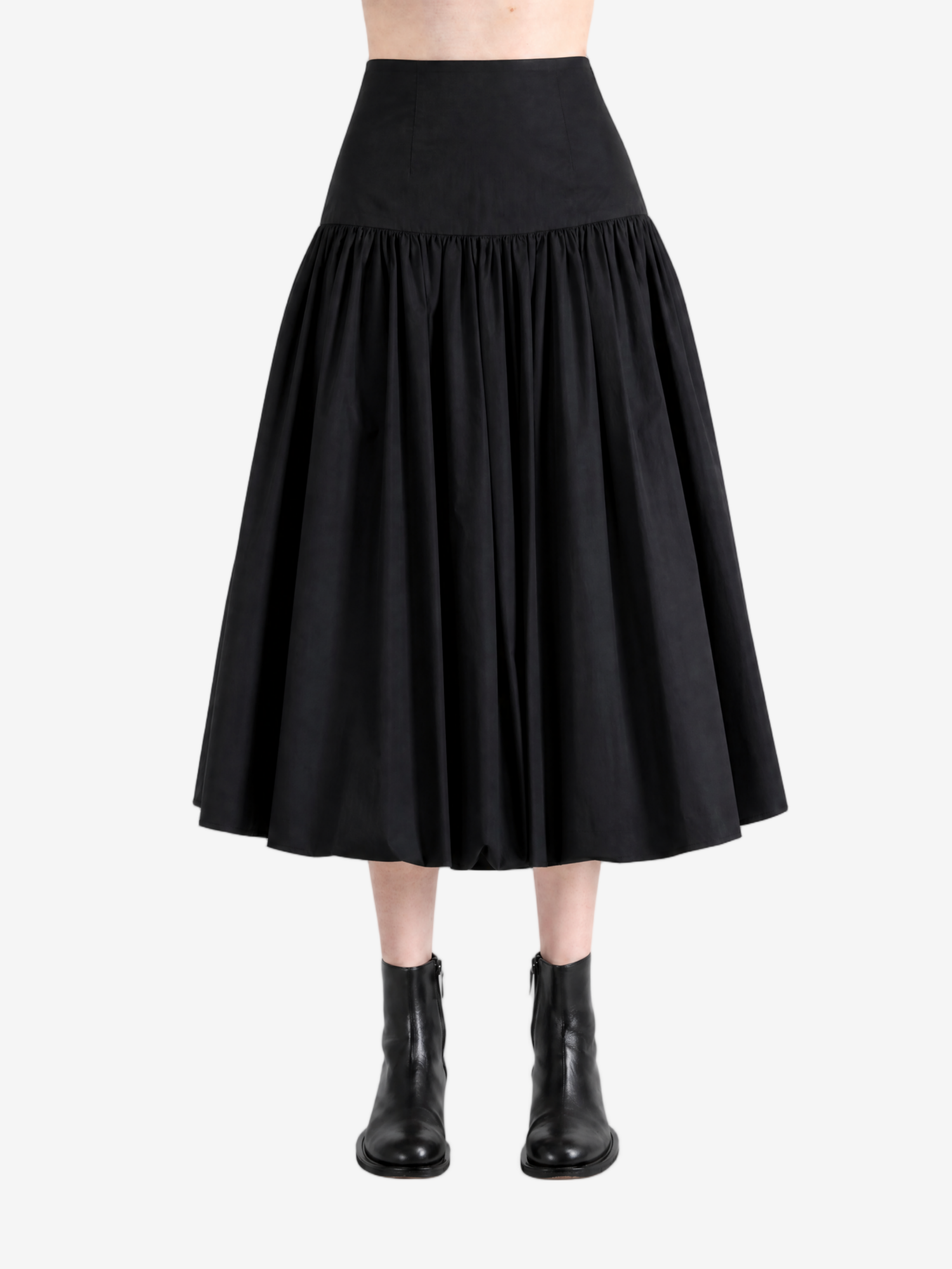 Black pants worn by a person, showing the pants' fit