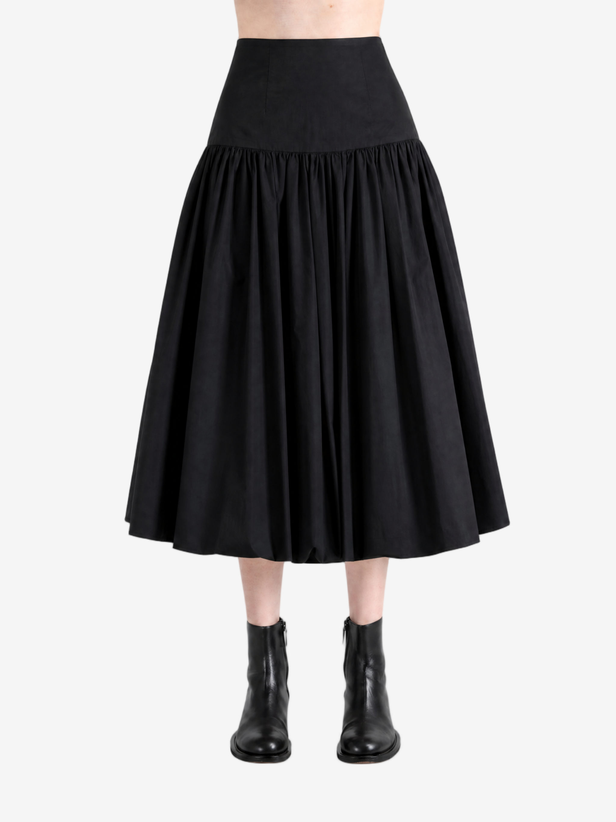 Black pants worn by a person, showing the pants' fit