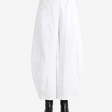 White pants worn by a person, showing the pants' fit
