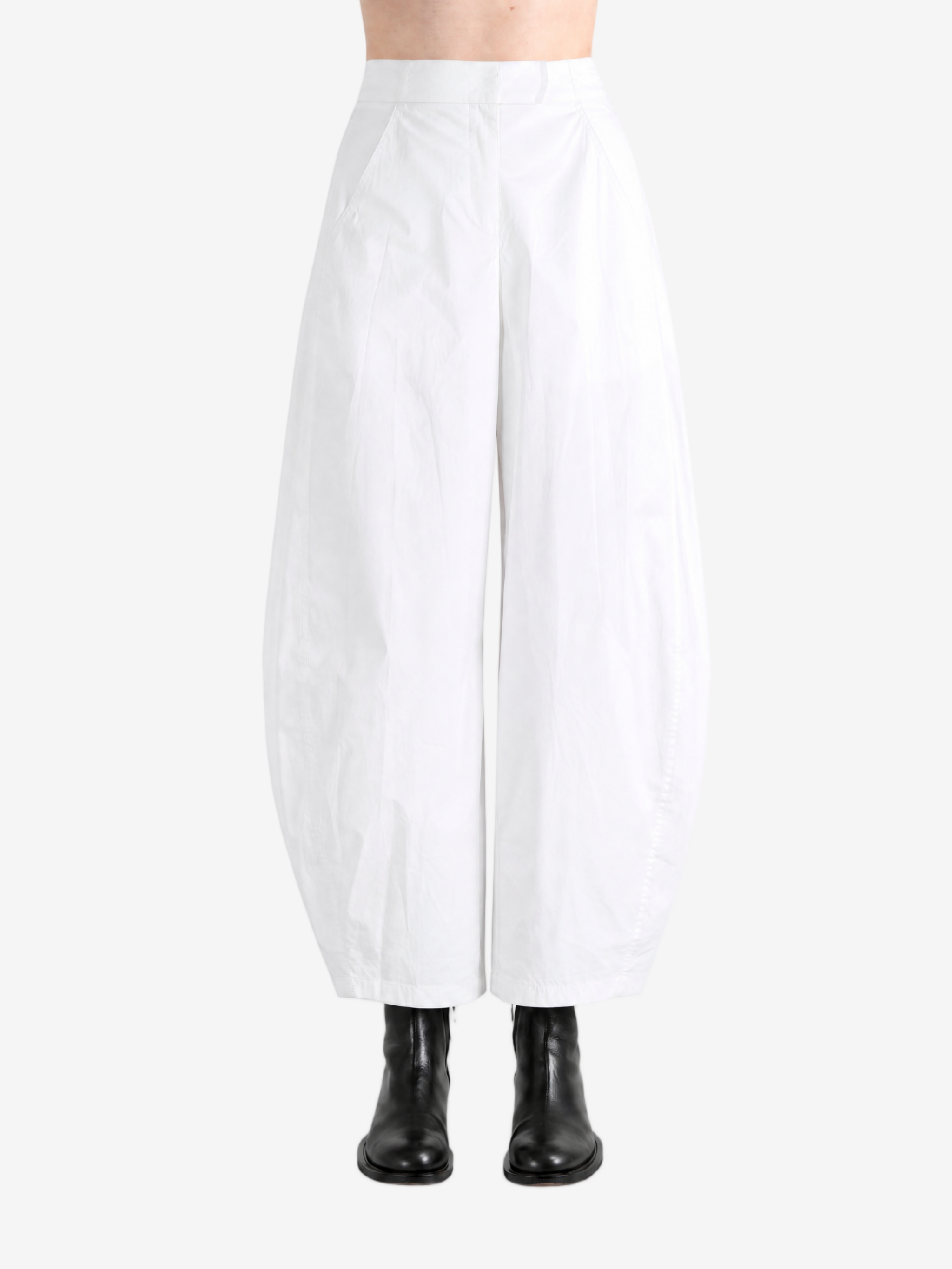 White pants worn by a person, showing the pants' fit
