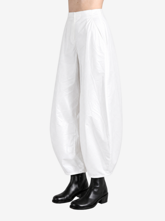 White pants worn by a person, showing the pants' fit