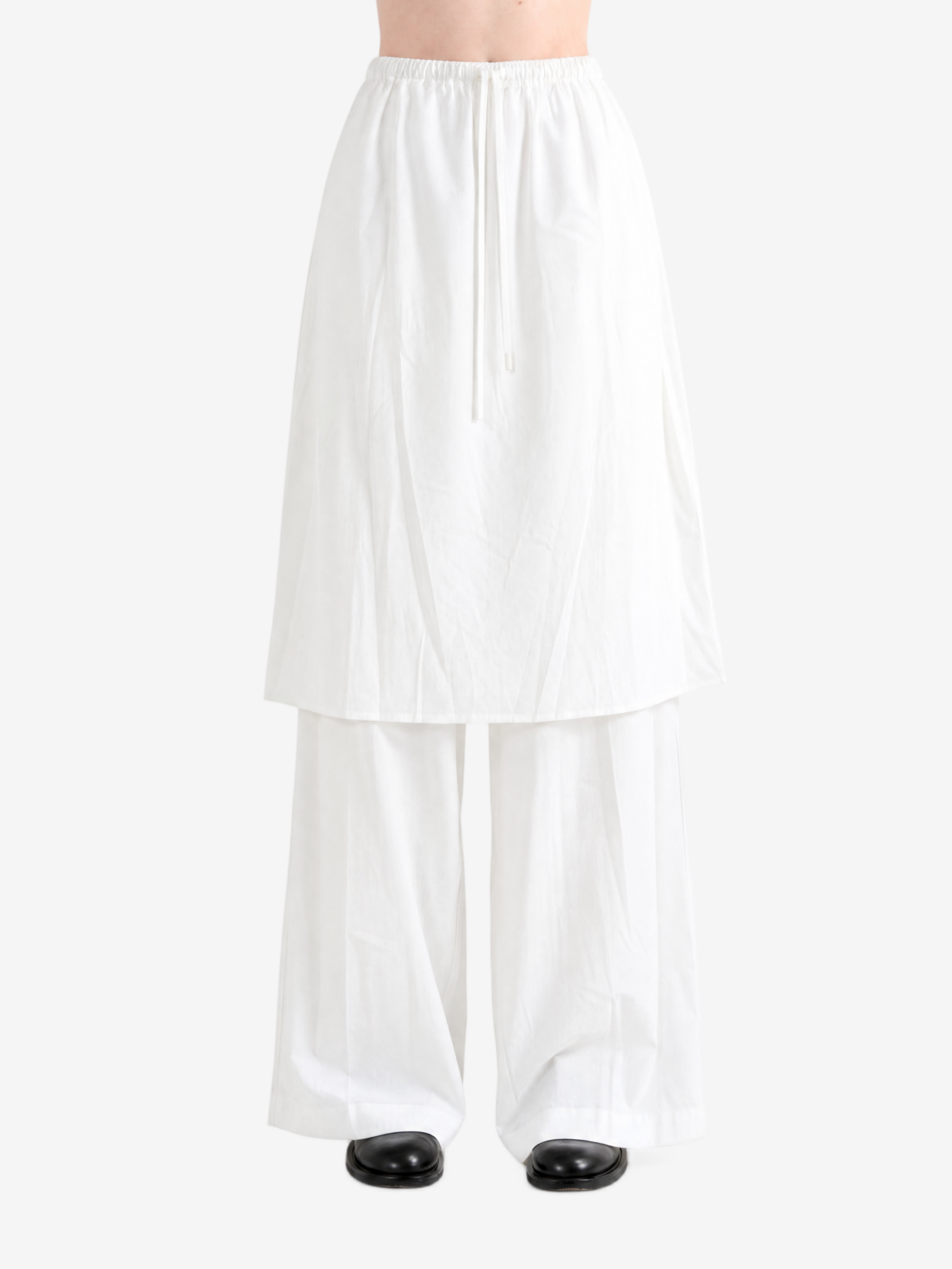 White pants worn by a person, showing the pants fit