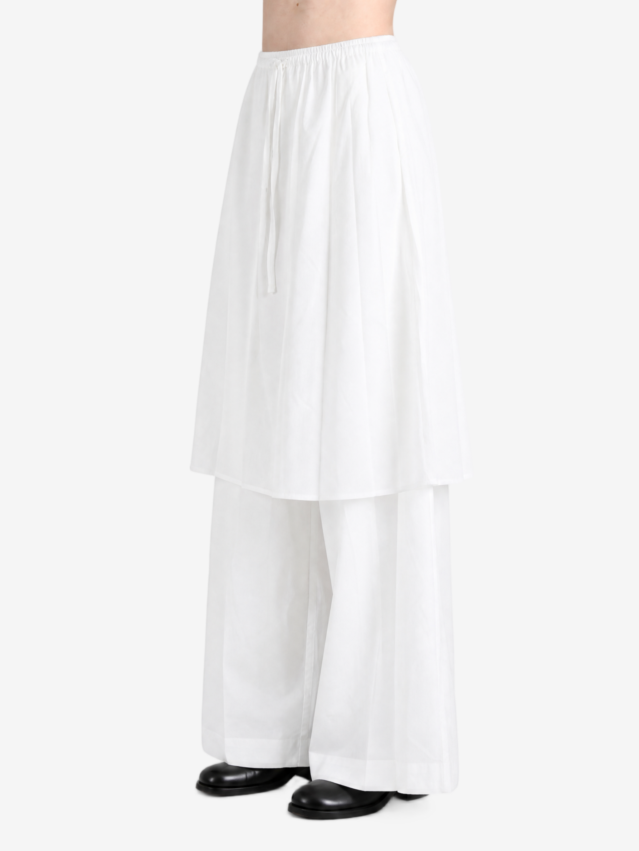 White pants worn by a person, showing the pants fit