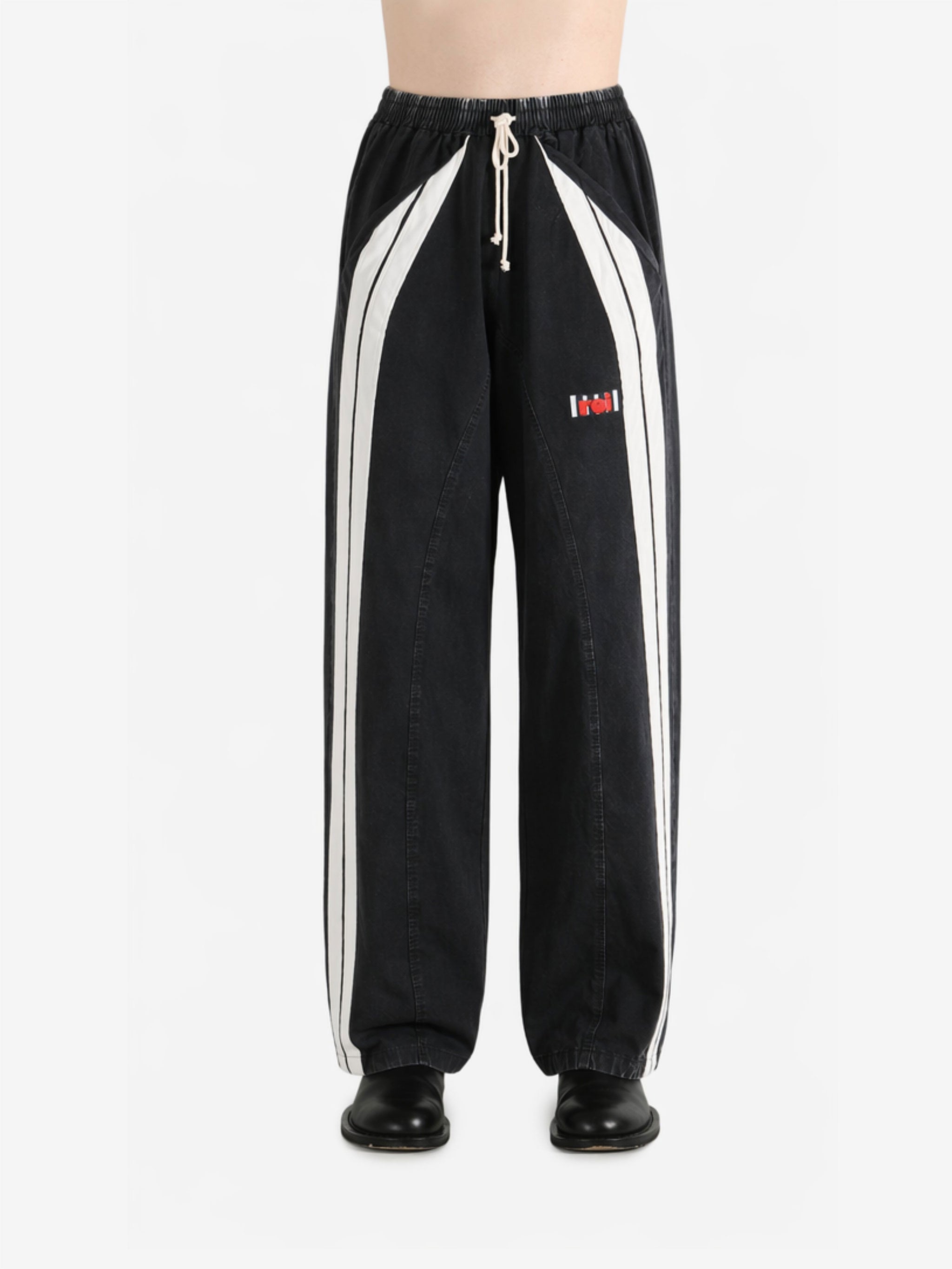 Black pants worn by a person, showing the pants fit