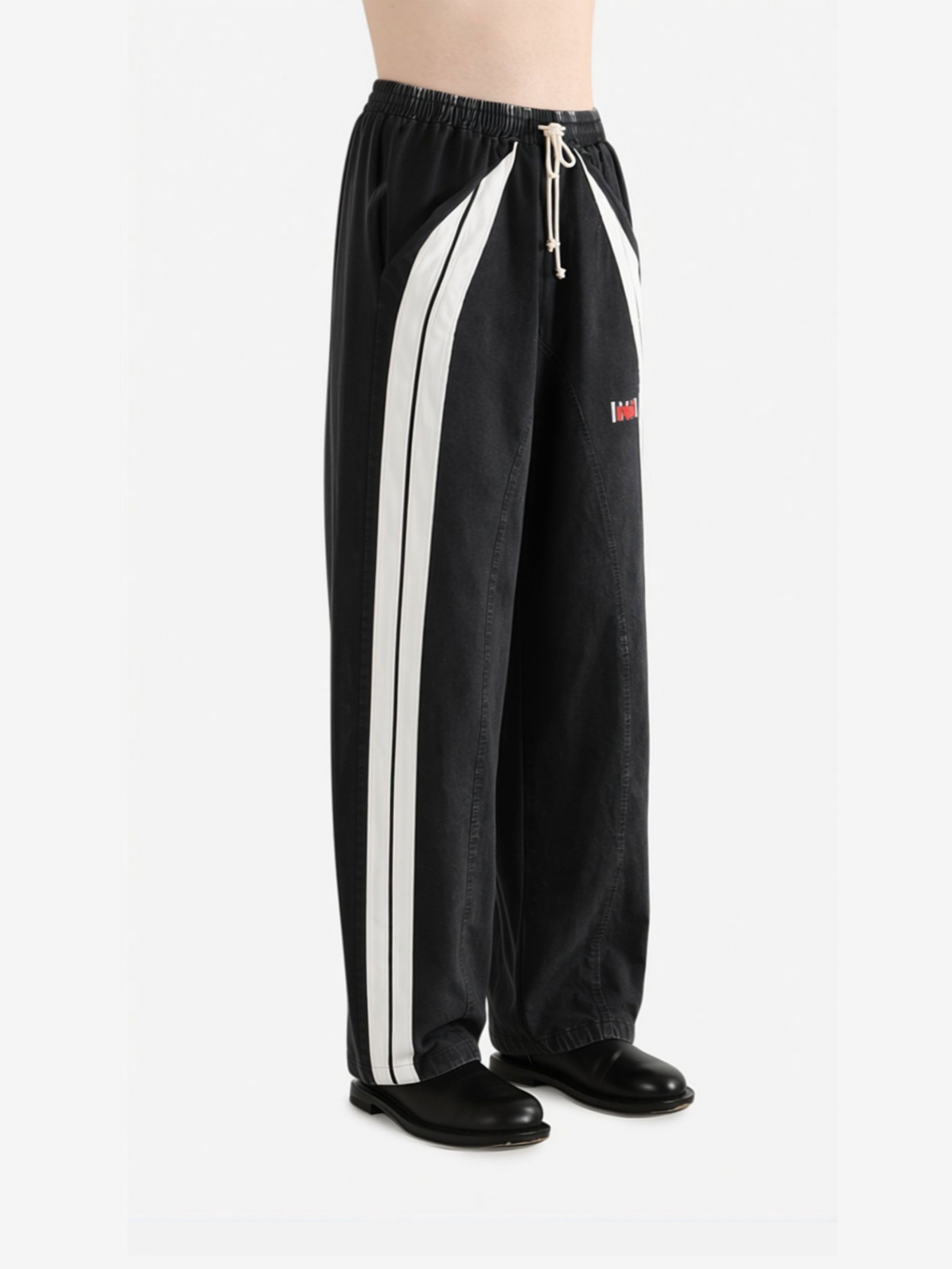 Black pants worn by a person, side view