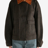 Brown jacket worn by a person, showing the jacket's fit