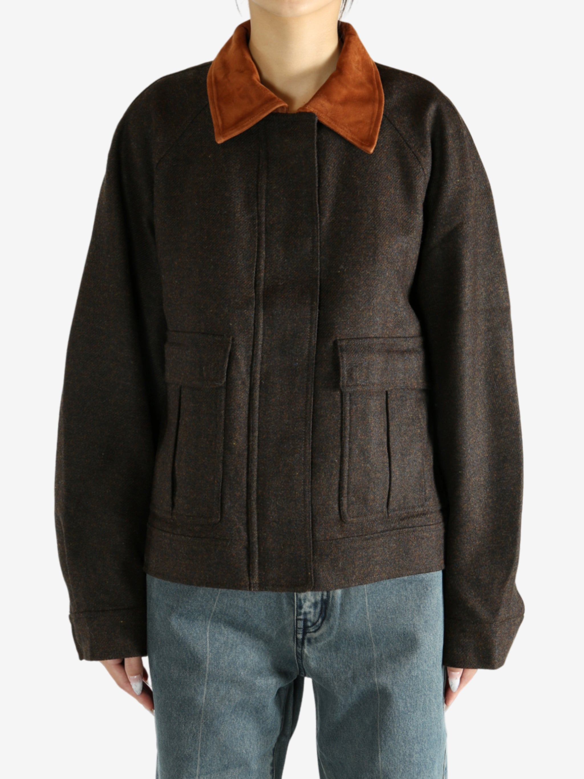 Brown jacket worn by a person, showing the jacket's fit