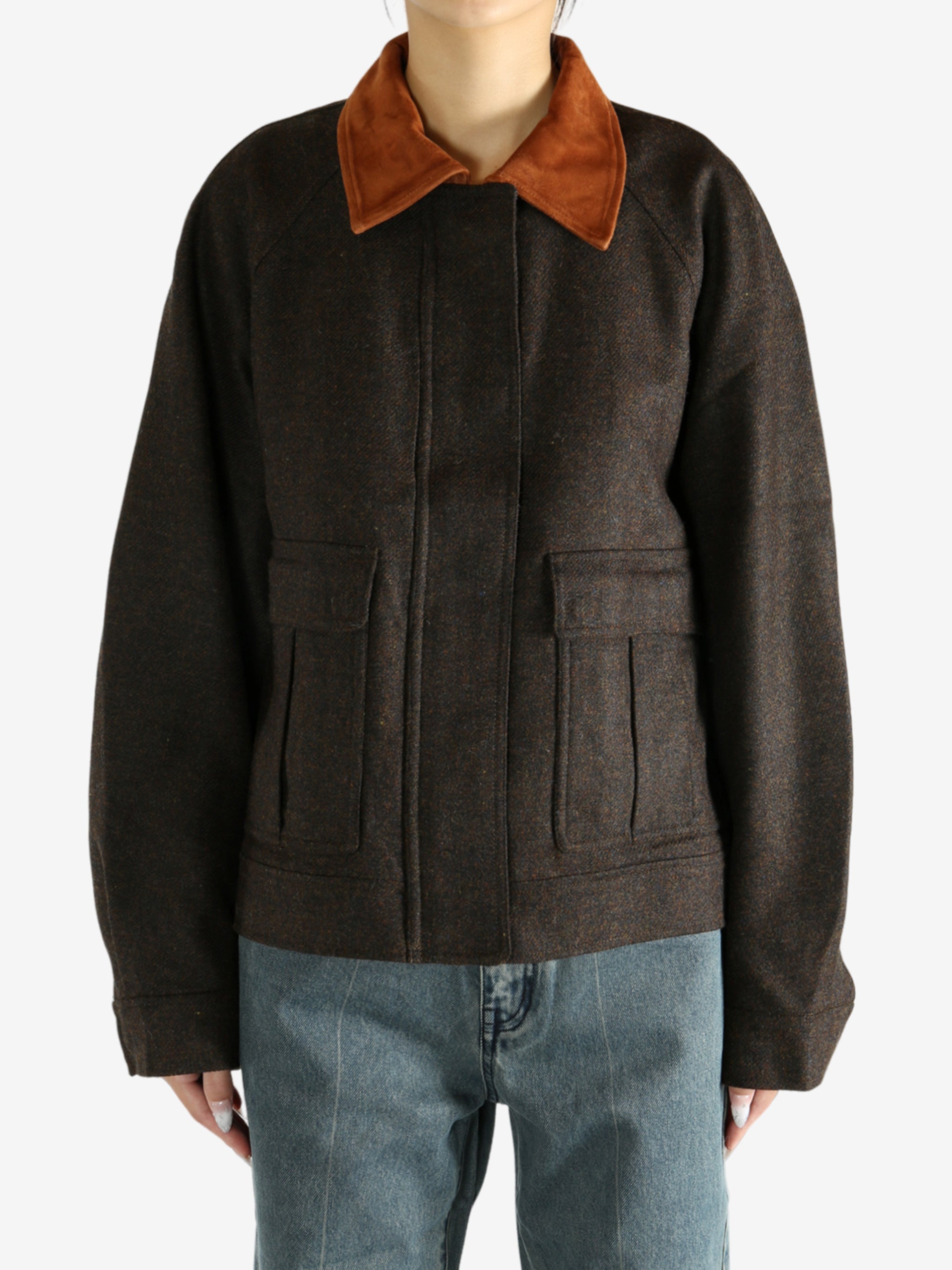 Brown jacket worn by a person, showing the jacket's fit