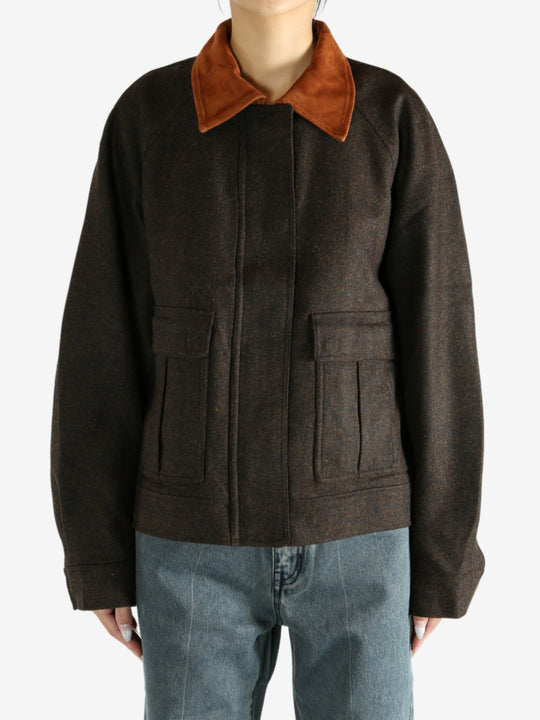 Brown jacket worn by a person, showing the jacket's fit