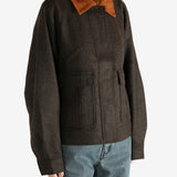 Brown jacket worn by a person, showing the jacket's fit