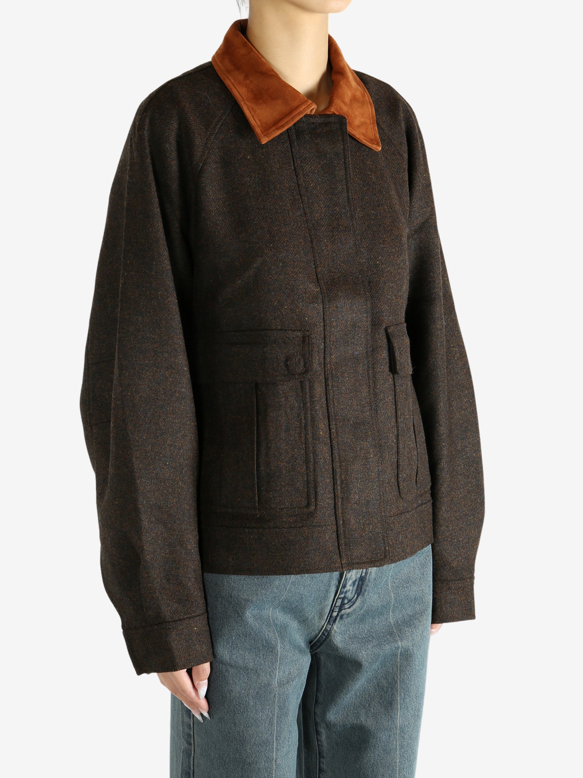 Brown jacket worn by a person, showing the jacket's fit