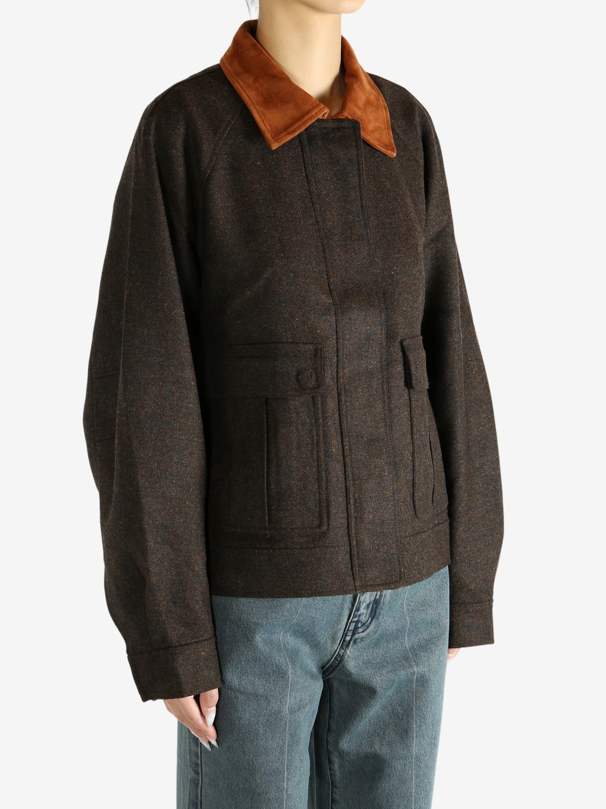 Brown jacket worn by a person, showing the jacket's fit