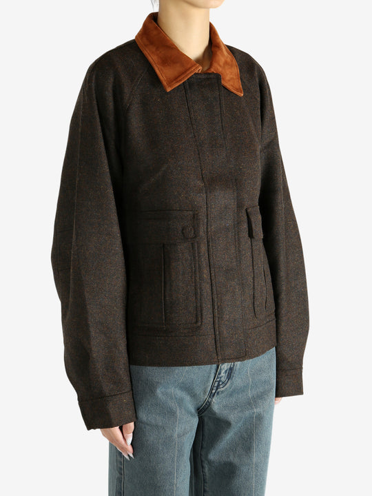 Brown jacket worn by a person, showing the jacket's fit