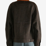 Brown jacket worn by a person, showing the jacket's fit