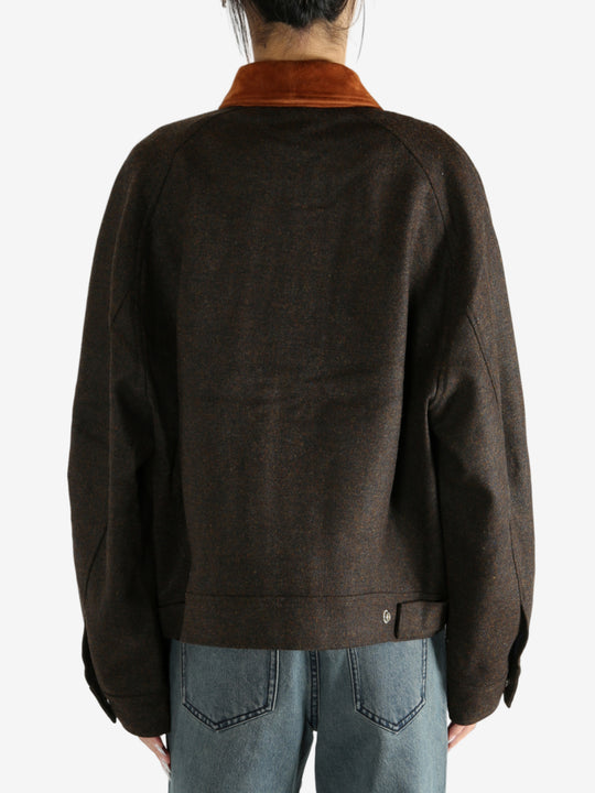 Brown jacket worn by a person, showing the jacket's fit