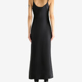 Black dress worn by a person, showing the skirt's fit