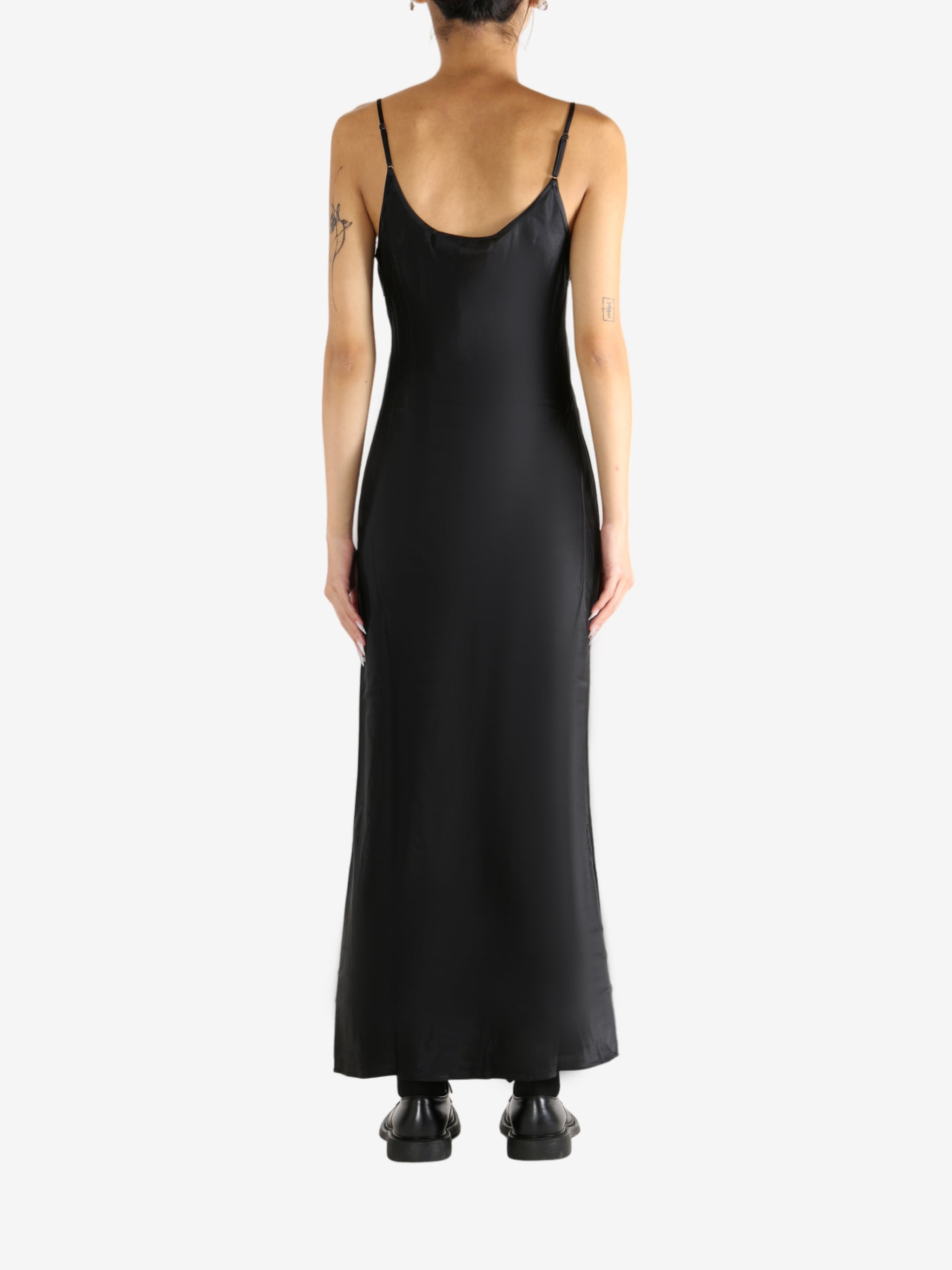 Black dress worn by a person, showing the skirt's fit