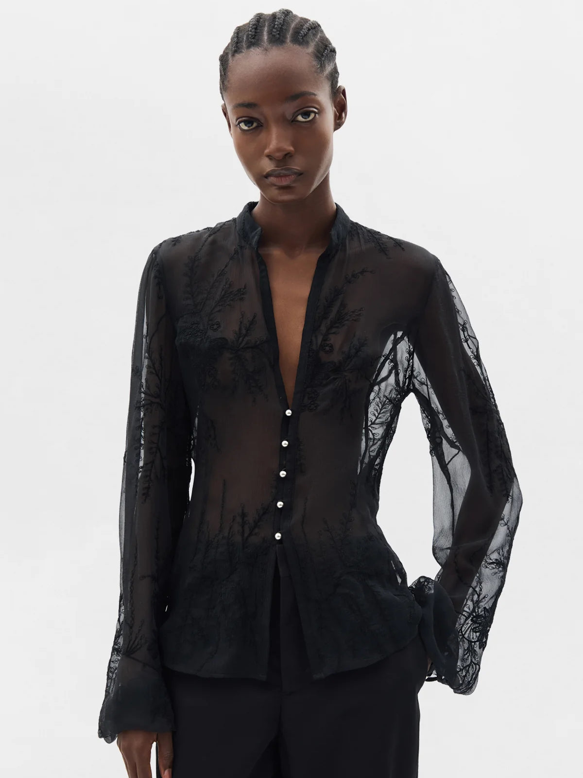 Black shirts worn by a person, showing the shirt's fit