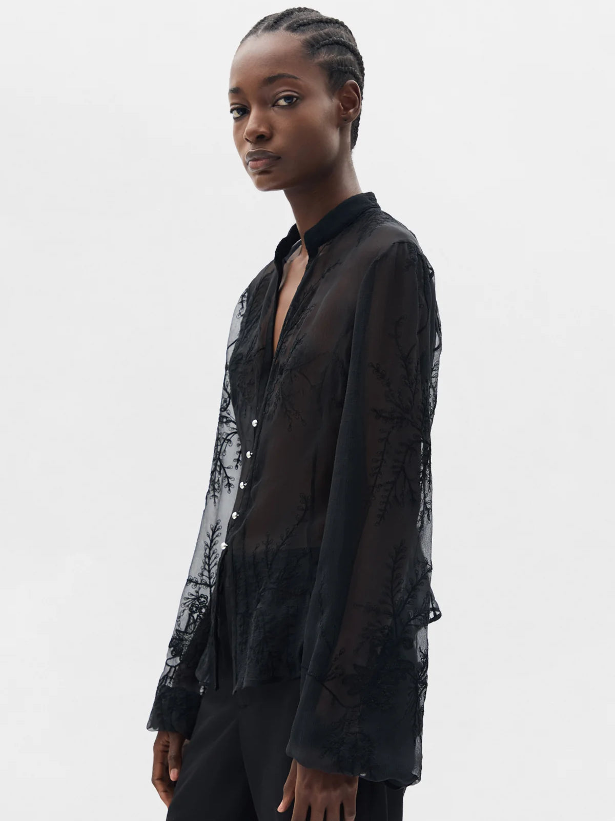 Black shirts worn by a person, showing the shirt's fit
