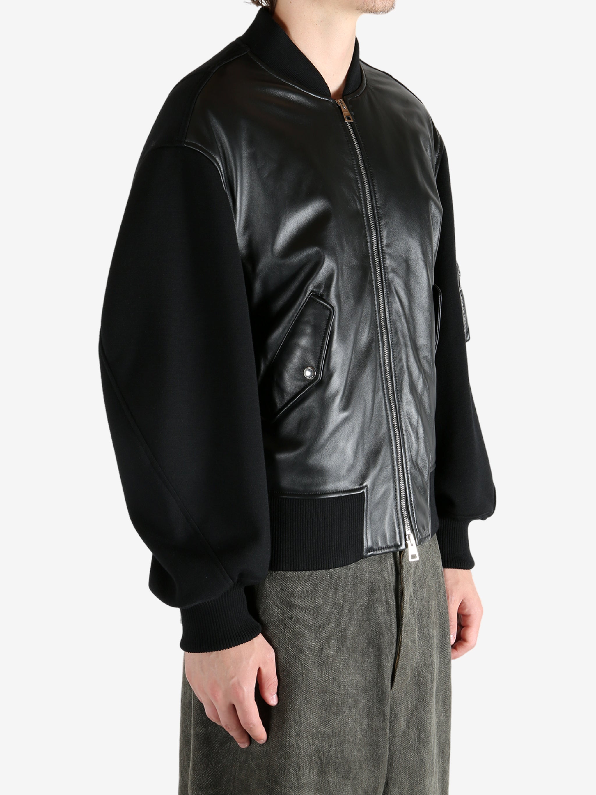 Black jacket worn by a person, showing the jacket's fit