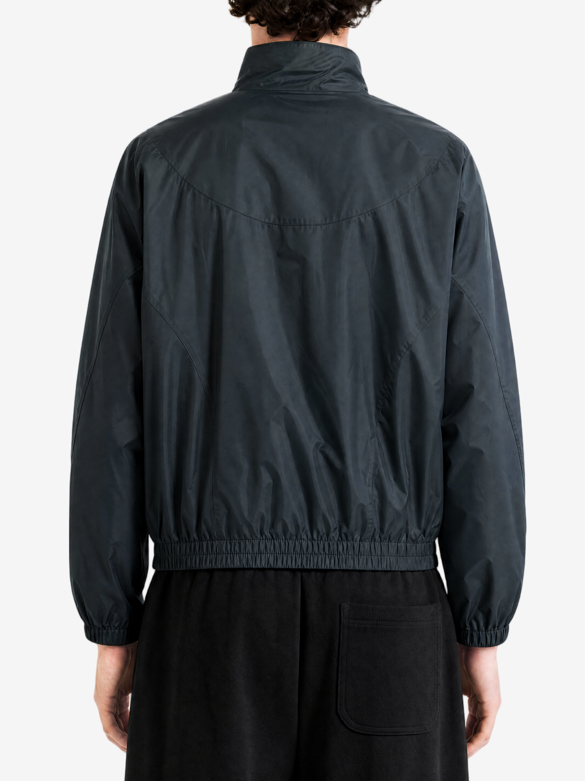 Black jacket worn by a person, back view