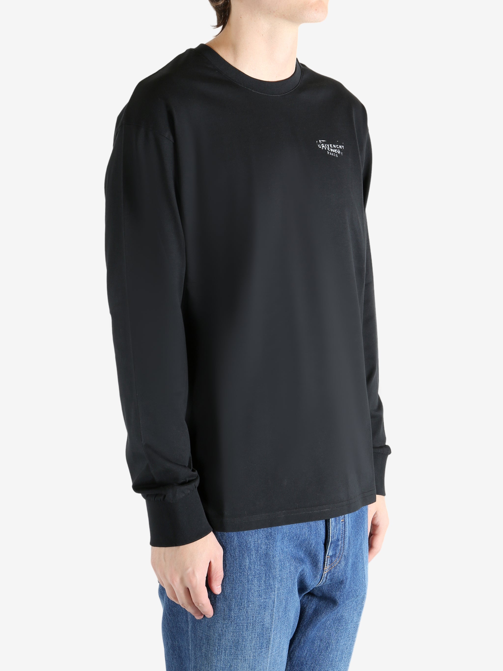 Black t-shirt worn by a person, showing the shirt's fit