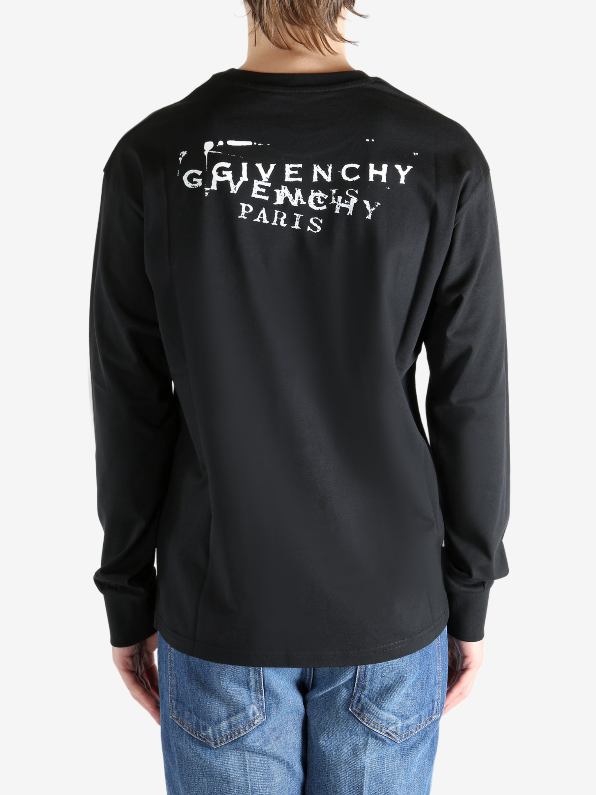 Black t-shirt worn by a person, showing the shirt's fit