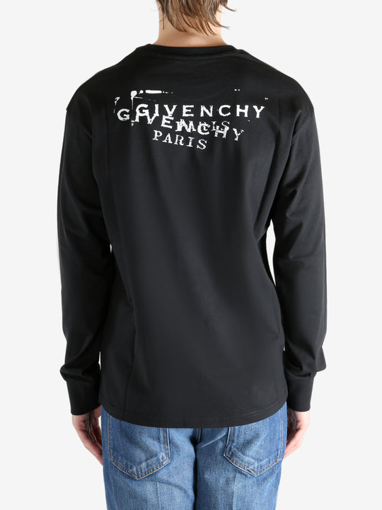 Black t-shirt worn by a person, showing the shirt's fit