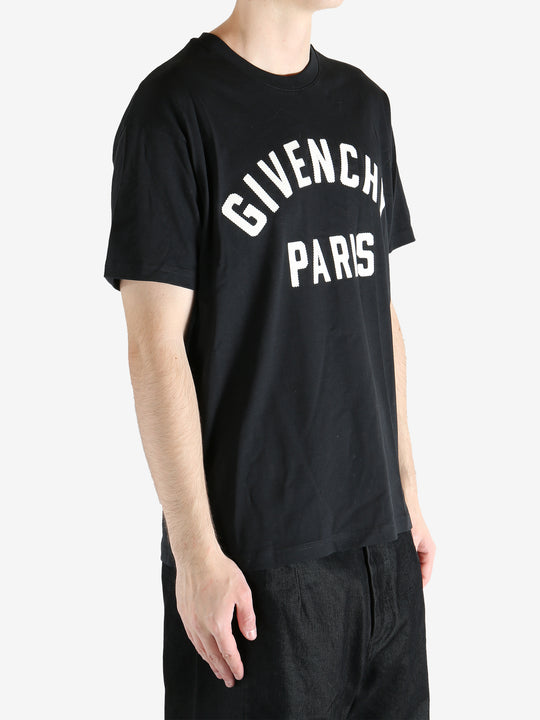 Black t-shirts worn by a person, showing the t-shirts fit