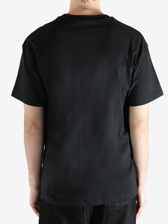 Black t-shirts worn by a person, showing the t-shirts fit