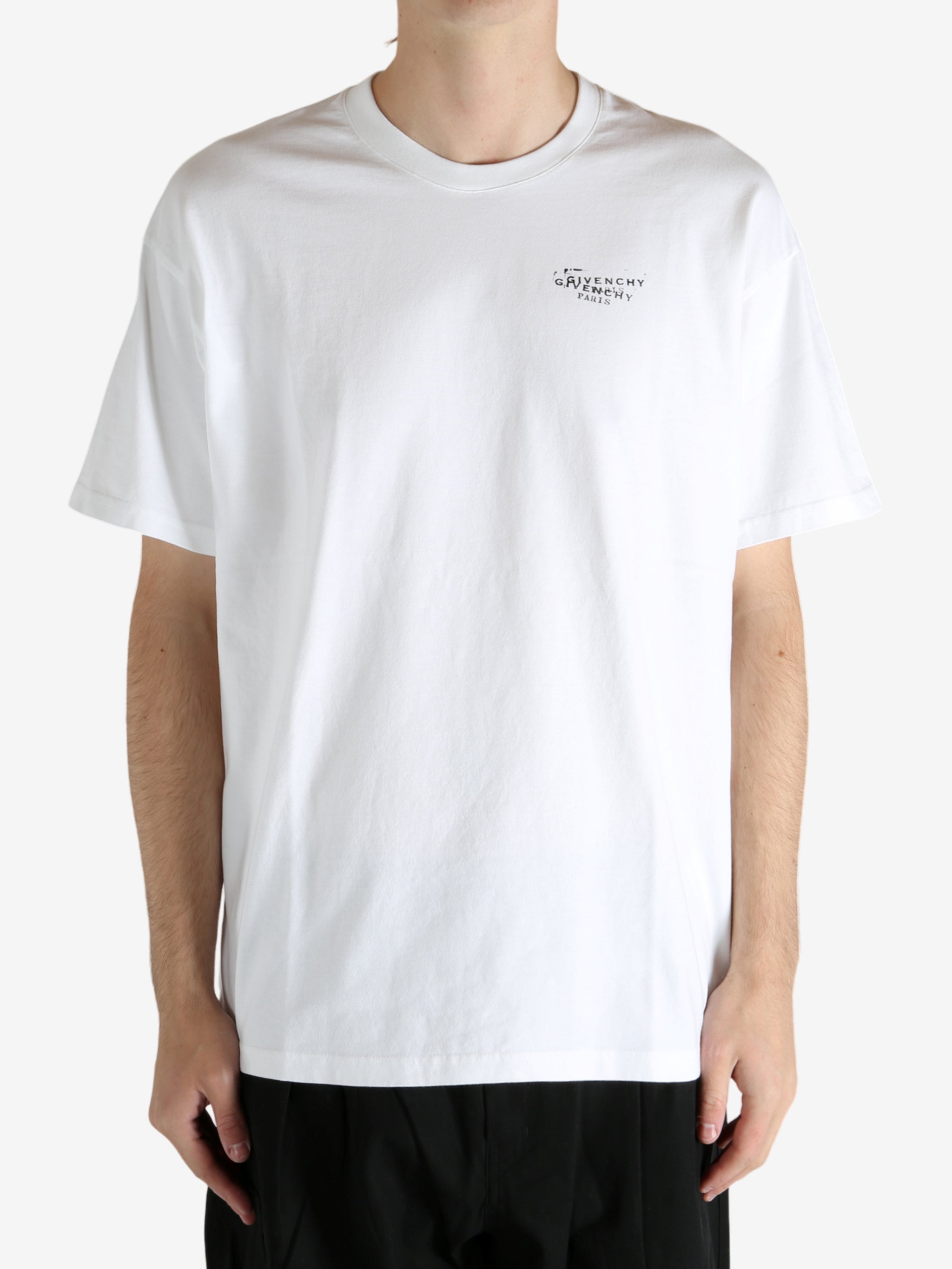 White t-shirt worn by a person, showing the t-shirt's fit