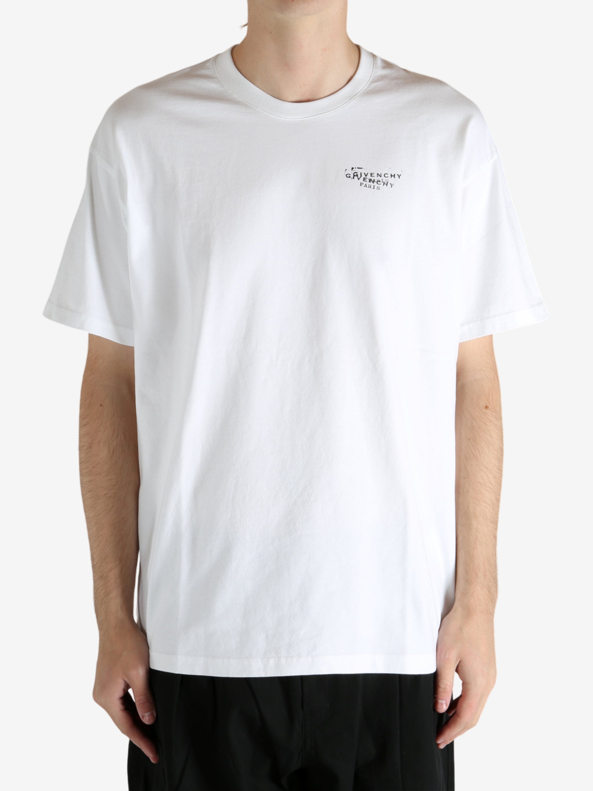 White t-shirt worn by a person, showing the t-shirt's fit