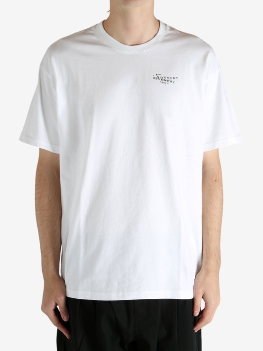 White t-shirt worn by a person, showing the t-shirt's fit