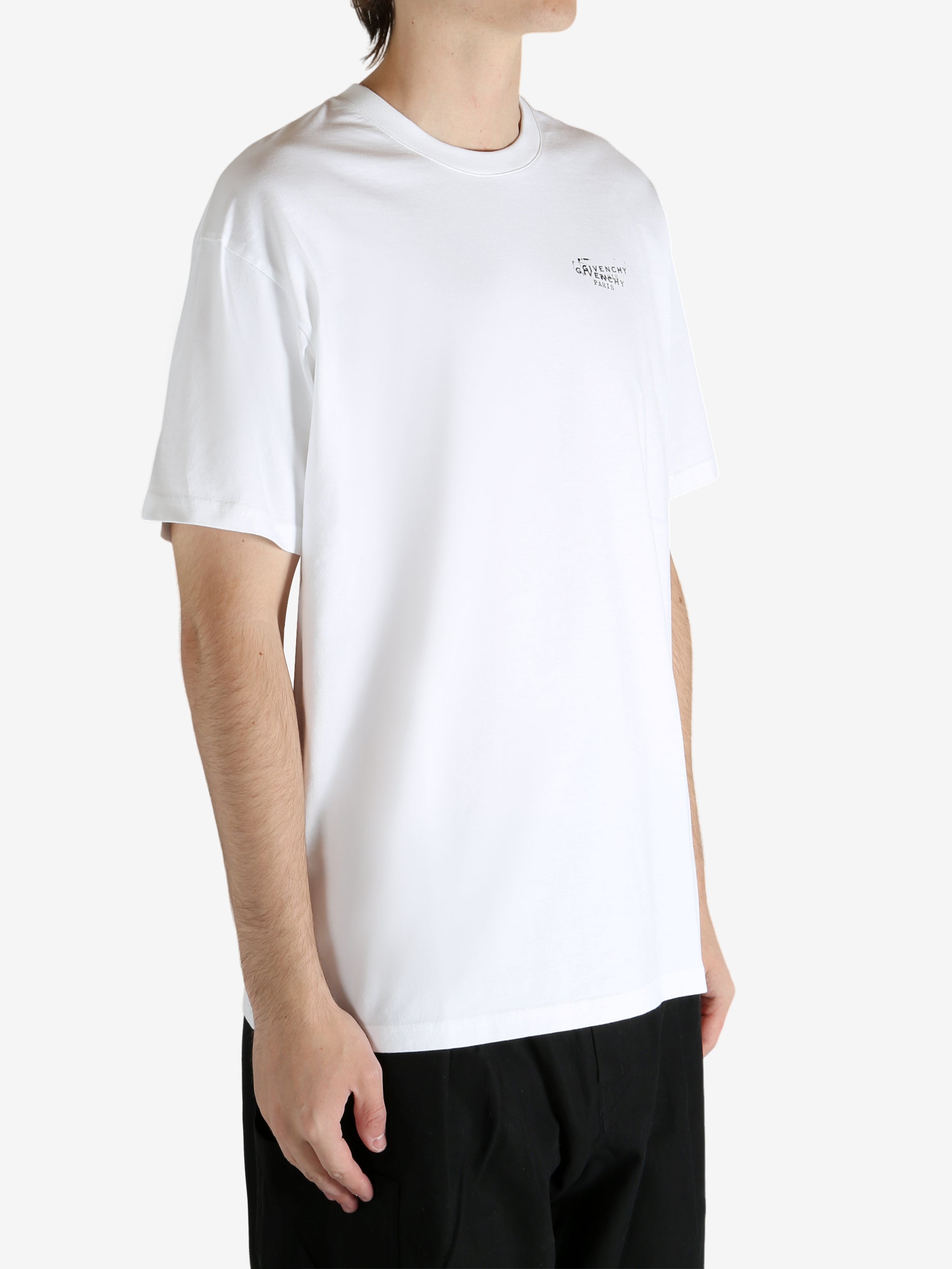 White t-shirt worn by a person, showing the t-shirt's fit