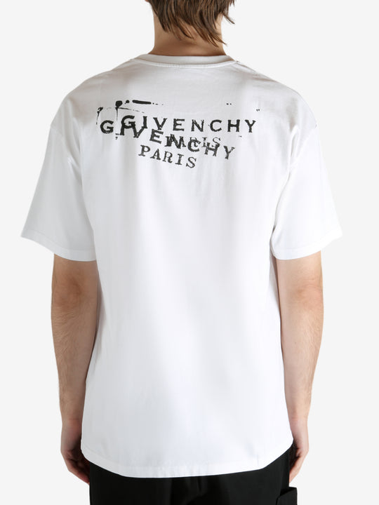 White t-shirt worn by a person, showing the t-shirt's fit